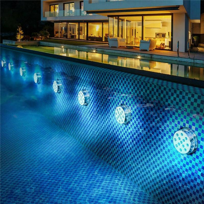Round LED lights illuminating the side of a swimming pool at night