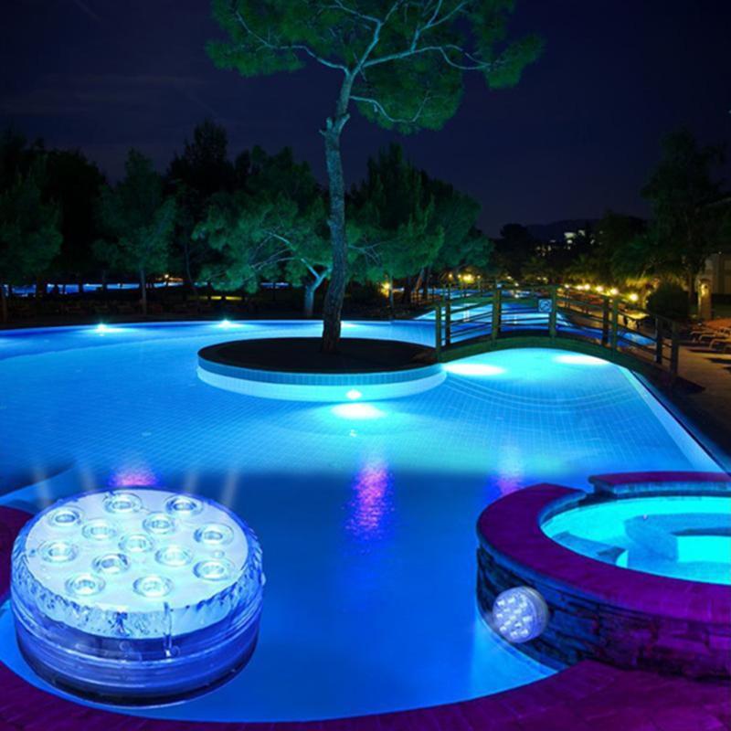 Round blue LED light pictured beside an illuminated swimming pool