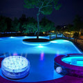 Round blue LED light pictured beside an illuminated swimming pool