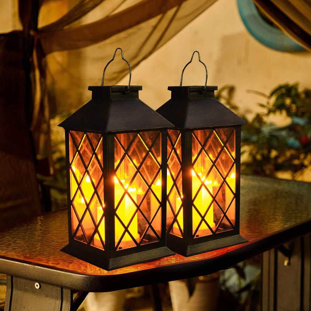 Two illuminated lanterns displayed together on a tabletop
