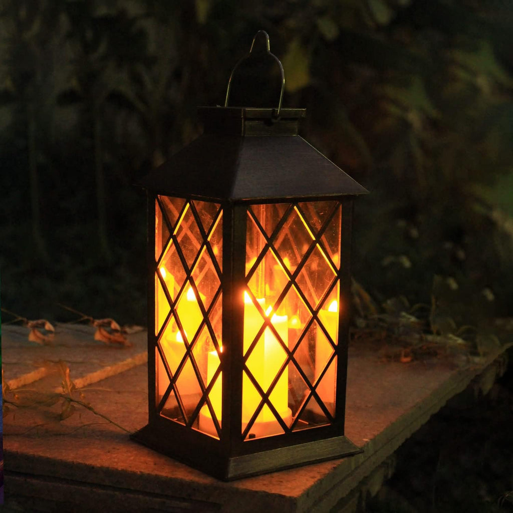 Lantern with glowing candle-shaped lights on a tabletop at night