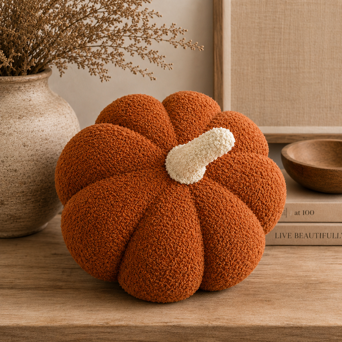 Single burnt orange sherpa pumpkin pillow displayed on a table