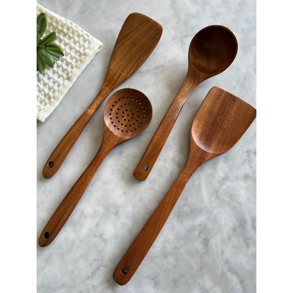Four-piece teak wood utensil set showing the different head shapes