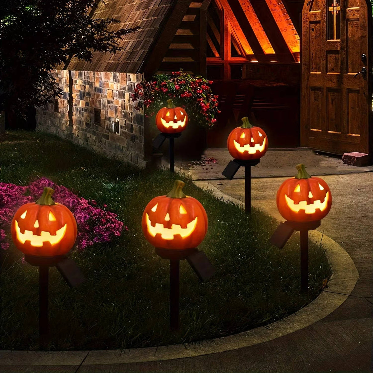 Glowing pumpkin lights along a curving garden path