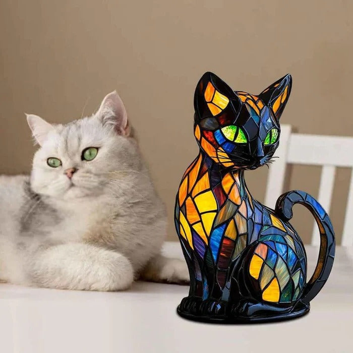 Colorful cat-shaped lamp displayed beside a resting cat