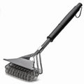 Bristle-free grill brush with a steel coil head, scraper, and black handle