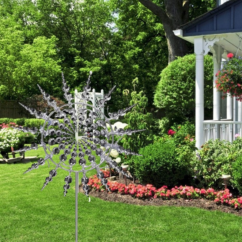 Metal wind spinner installed beside a garden path