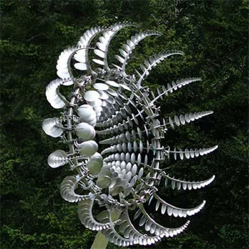 Metal kinetic wind spinner showing layered curved blades